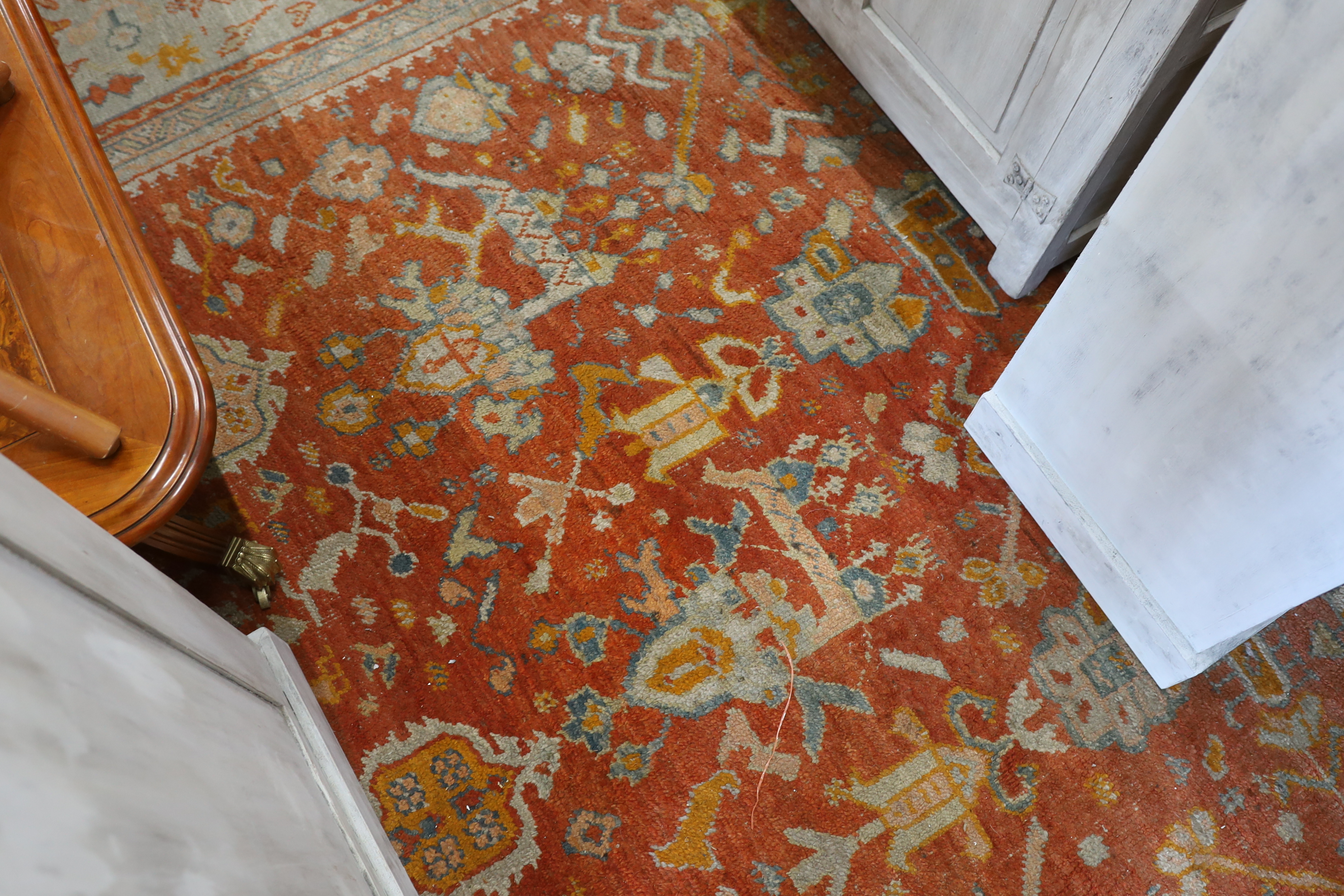 An Afghan red ground carpet, 395 x 310cm